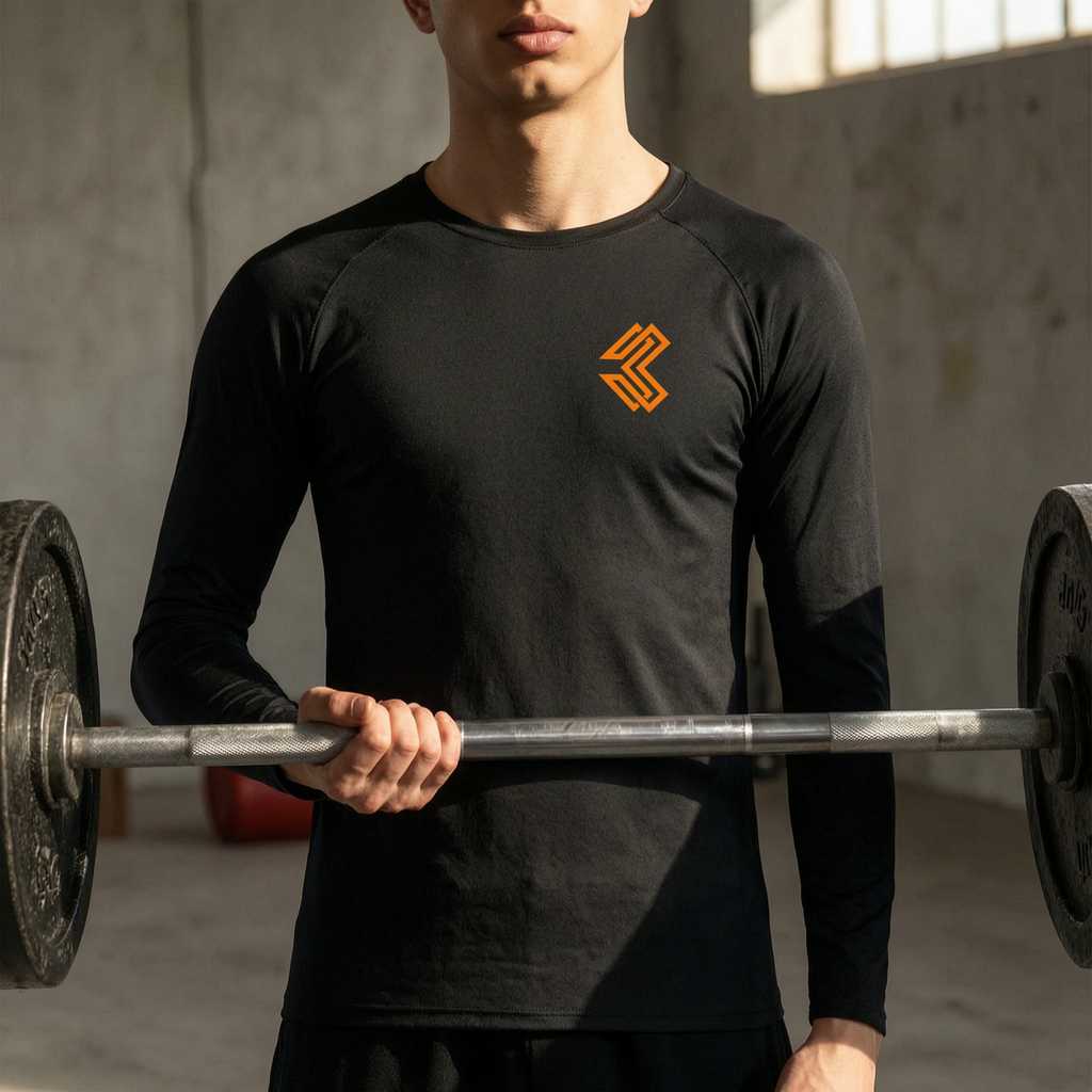 Liga Combat Rounds Long Sleeve worn in a gym holding a barbell, raglan sleeves to the wrist
