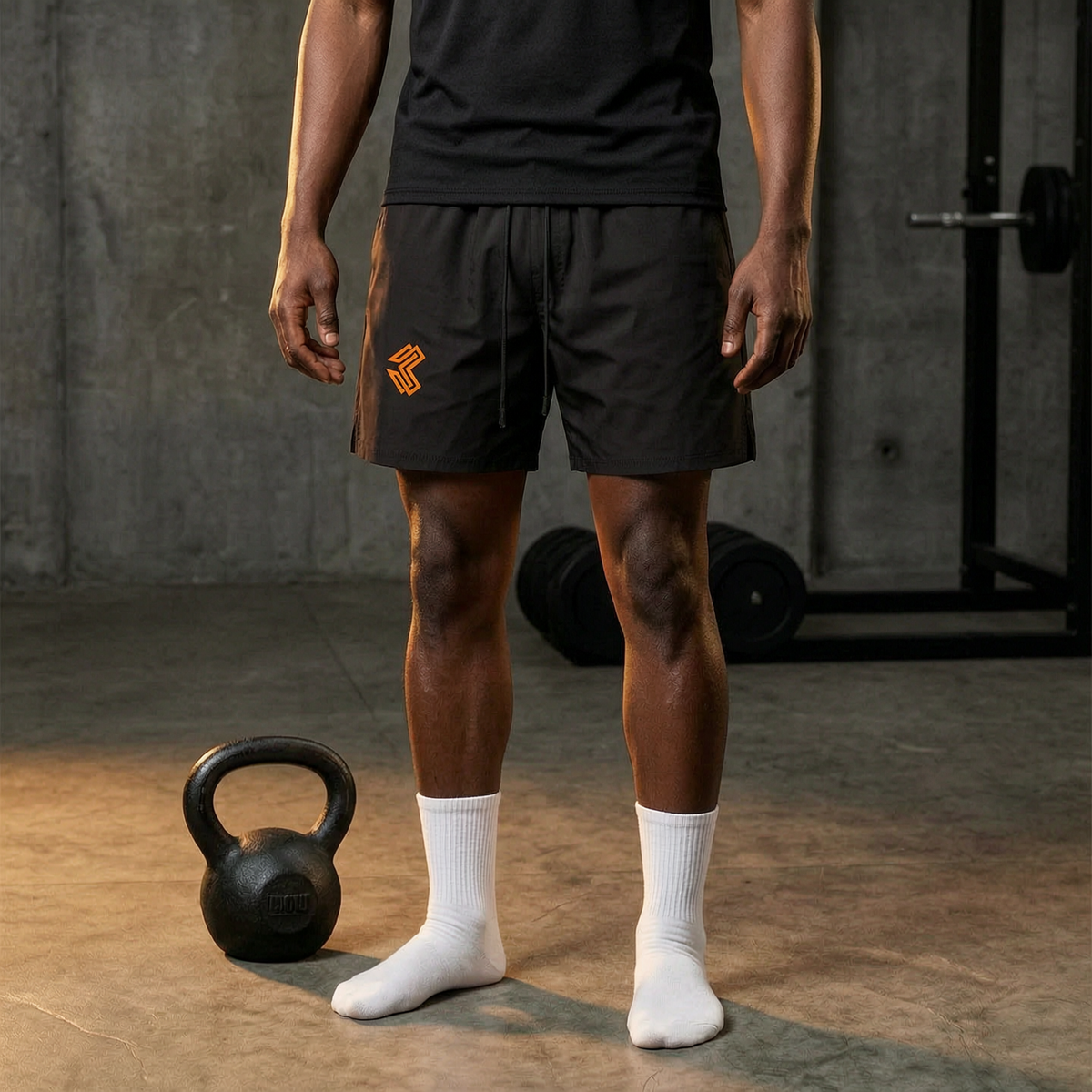 Liga Combat Rounds Training Shorts worn in a gym beside a kettlebell, black knee-length shorts