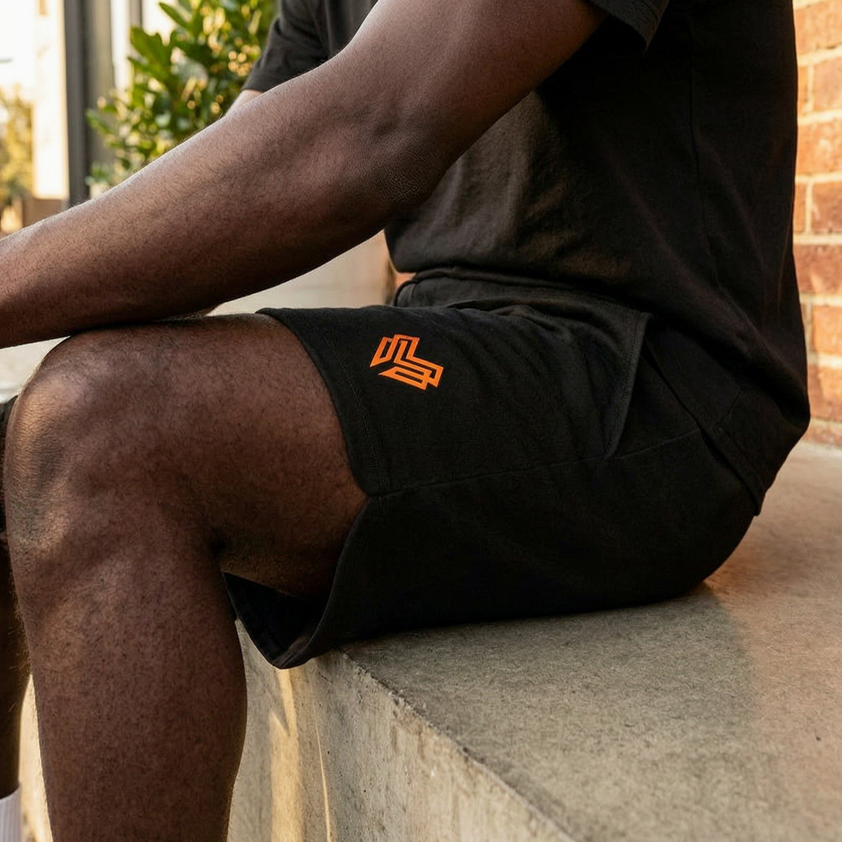Liga Combat Rounds 2-in-1 Shorts worn off the mats outside a cafe, black cotton-blend shorts