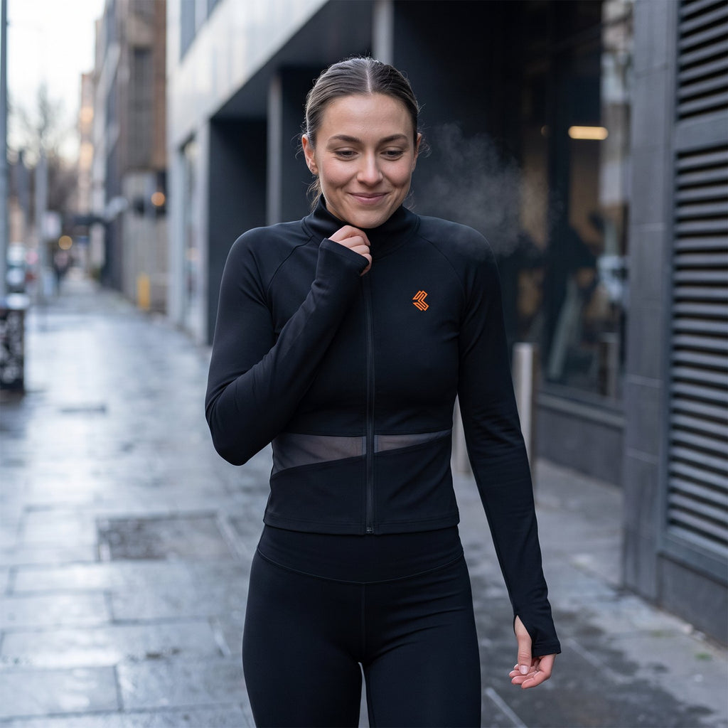 Liga Combat Between Rounds Jacket worn on the street after training, thumbholes at the cuffs
