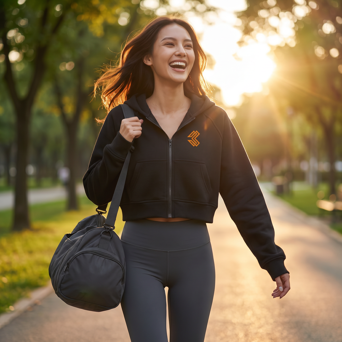 Liga Combat Ascend cropped black zip hoodie in a park after training