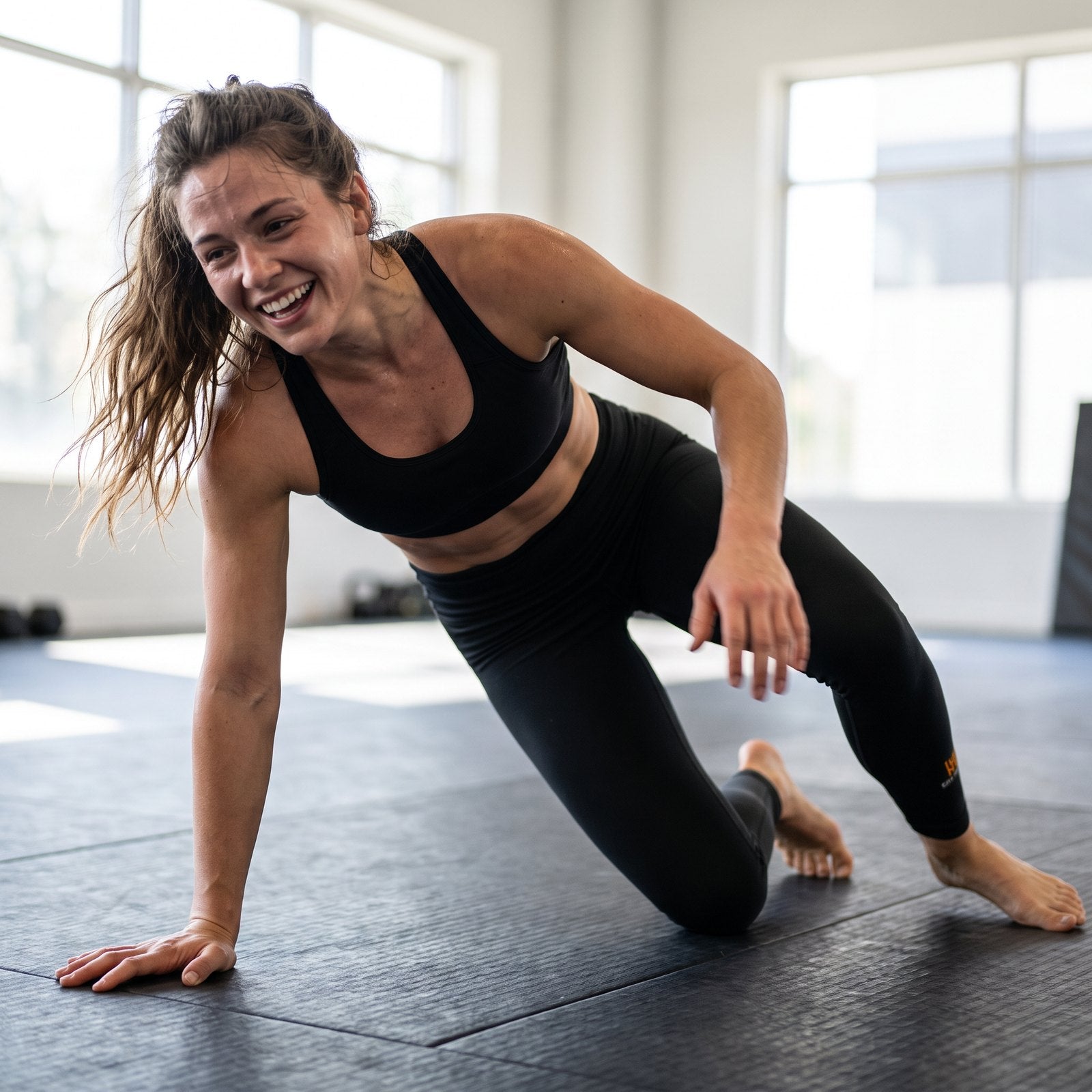 Liga Combat Mat Hours Legging worn rising off the mat mid-session at a jiu-jitsu gym